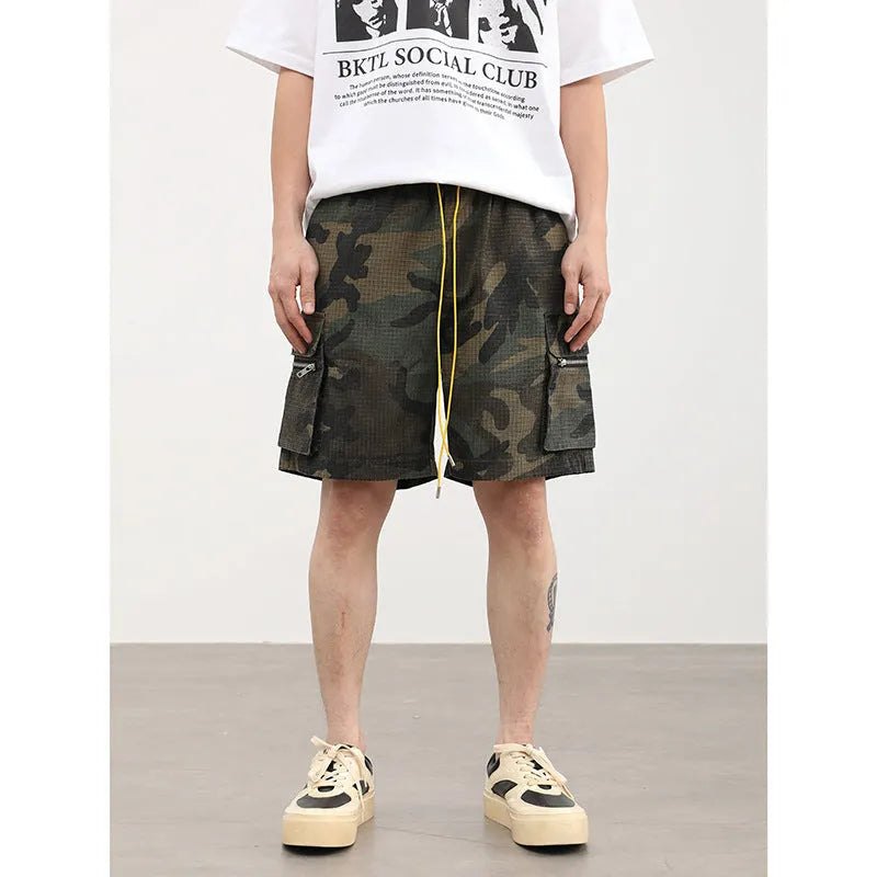 Men's camouflage cotton blend cargo shorts with multiple pockets, shown in a loose cropped fit.