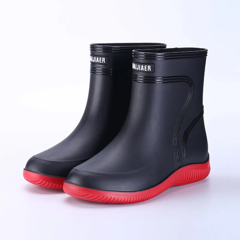 Men's mid-top PVC rain boots in black with green detailing, tassel decoration, and non-slip sole