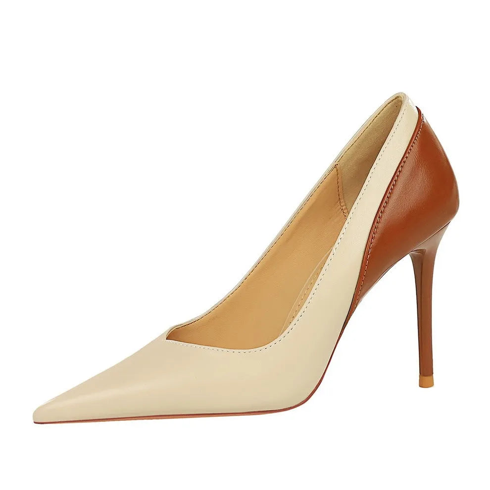 Retro-style black and creamy white women's stiletto high heels with pointed toe for banquet wear.