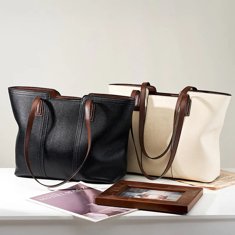 Women's black genuine leather crossbody bag showing horizontal square shape and internal organiser pockets