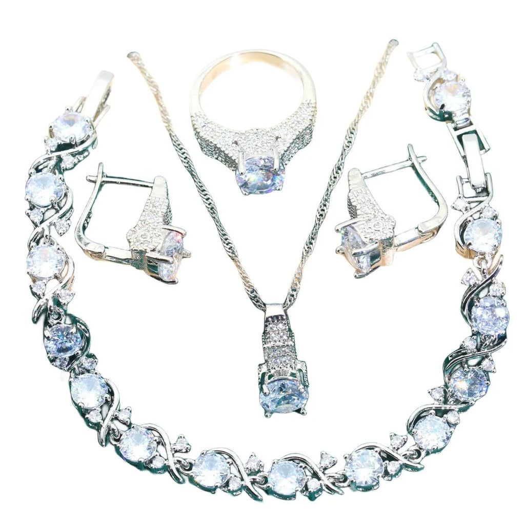Four-piece bridal zircon jewellery set showing necklace, bracelet, earrings, and ring in a choice of colours.