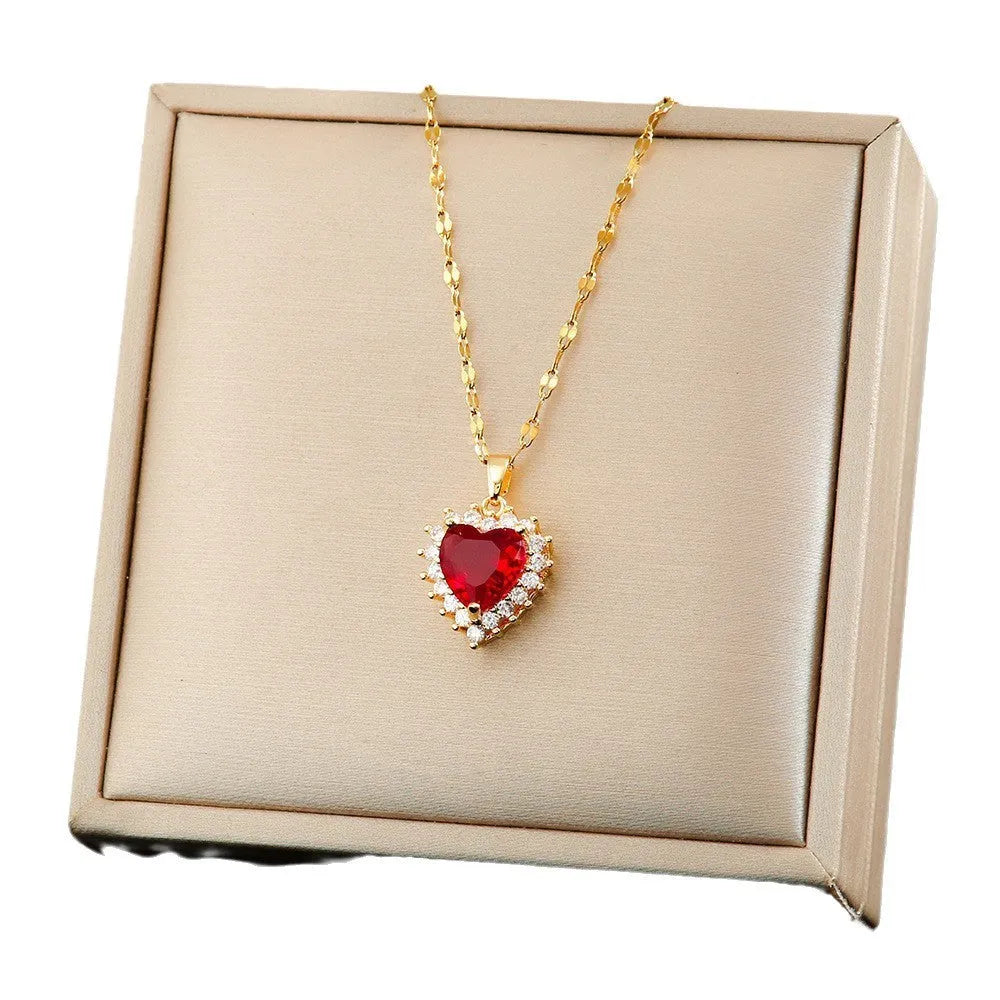 Gold red titanium steel necklace with heart floral pendant and matching stud earrings and ring set.