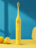 Small yellow duck design rechargeable electric toothbrush with soft bristles.