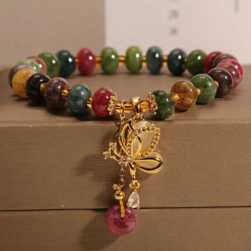 Colourful butterfly bracelet with alloy base and glass beads in tourmaline shades.