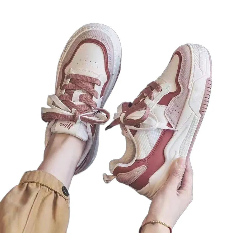 Women's beige and pink low-top rubber sole sneakers on a white background
