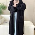 Loose grey hooded cardigan coat with long sleeves on a hanger