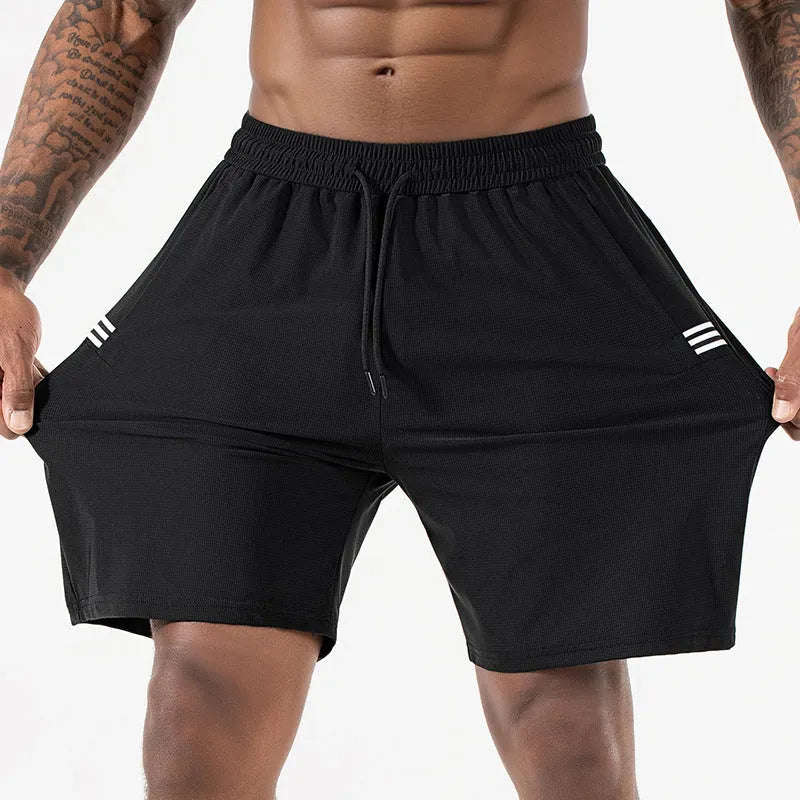 Man wearing black Ice Silk nylon sports shorts with a drawstring waist and cropped leg.
