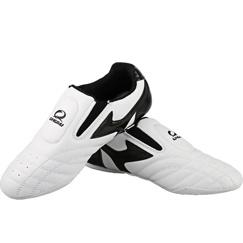 Black and white children's Sanda Taekwondo martial arts shoes with a soft sole and widened fit.