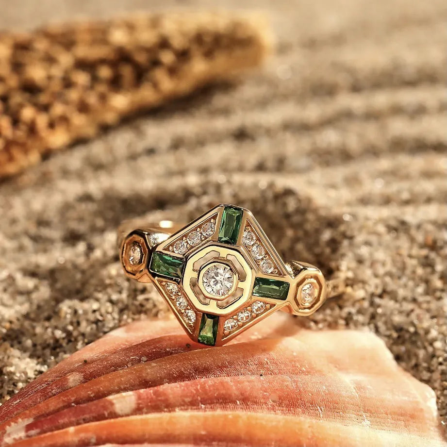 Square geometric emerald diamond ring for women with a green zircon stone on a finger.
