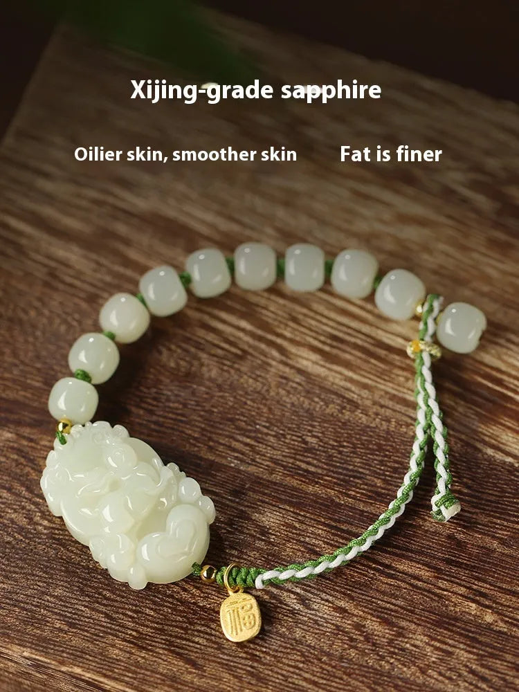 Rabbit Chinese zodiac bracelet with Hetian jade charm and silver card on a red rope.