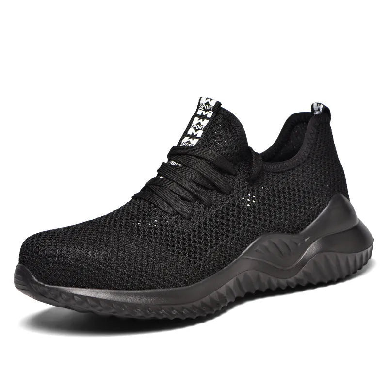 Low-cut black safety shoe with a steel toe cap on a grey background.