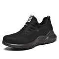 Low-cut black safety shoe with a steel toe cap on a grey background.