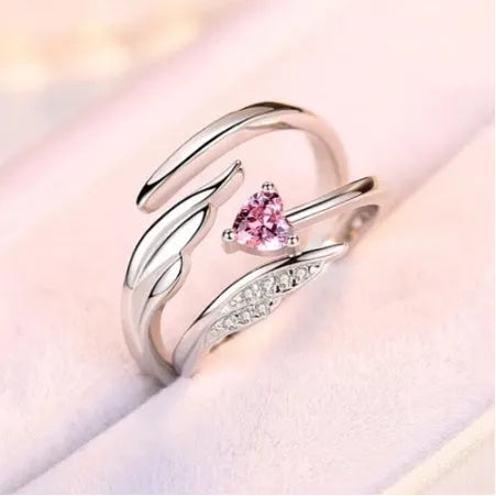 Silver adjustable heart diamond ring with geometric design on a plain background