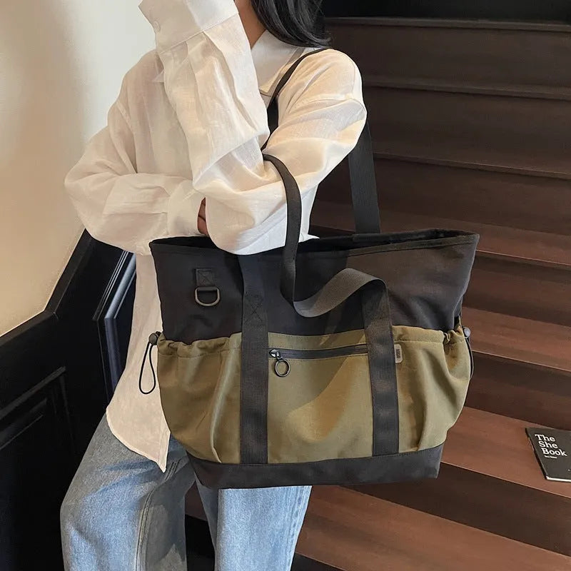 Lightweight Oxford cloth travel bag for women in grey, shown with a letter-pattern lining and holding a yoga mat.