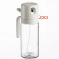 Warm grey glass oil sprayer and pourer bottle with switchable cap and detachable nozzle.