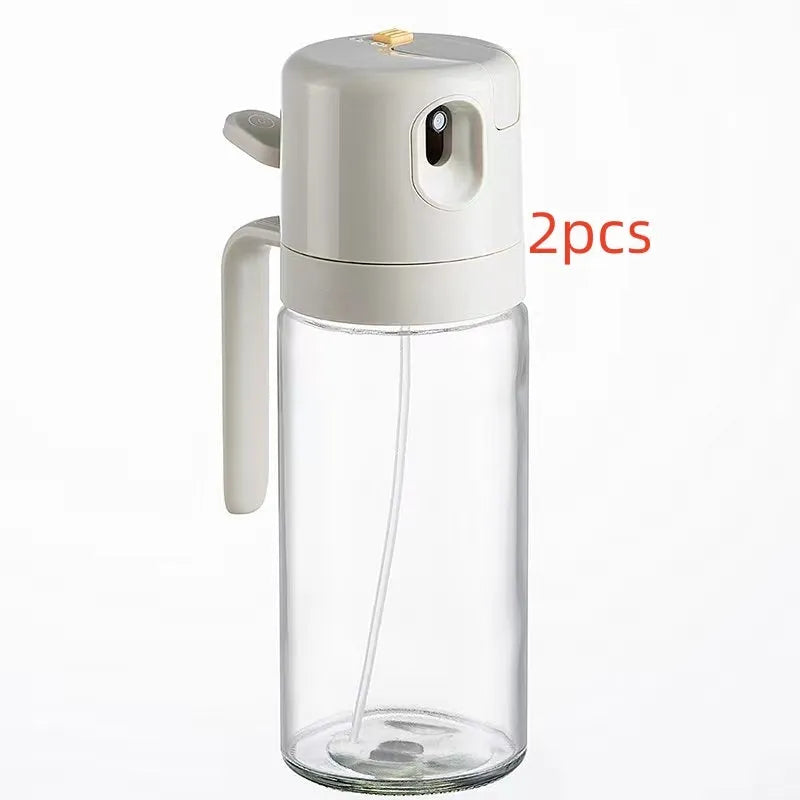Warm grey glass oil sprayer and pourer bottle with switchable cap and detachable nozzle.