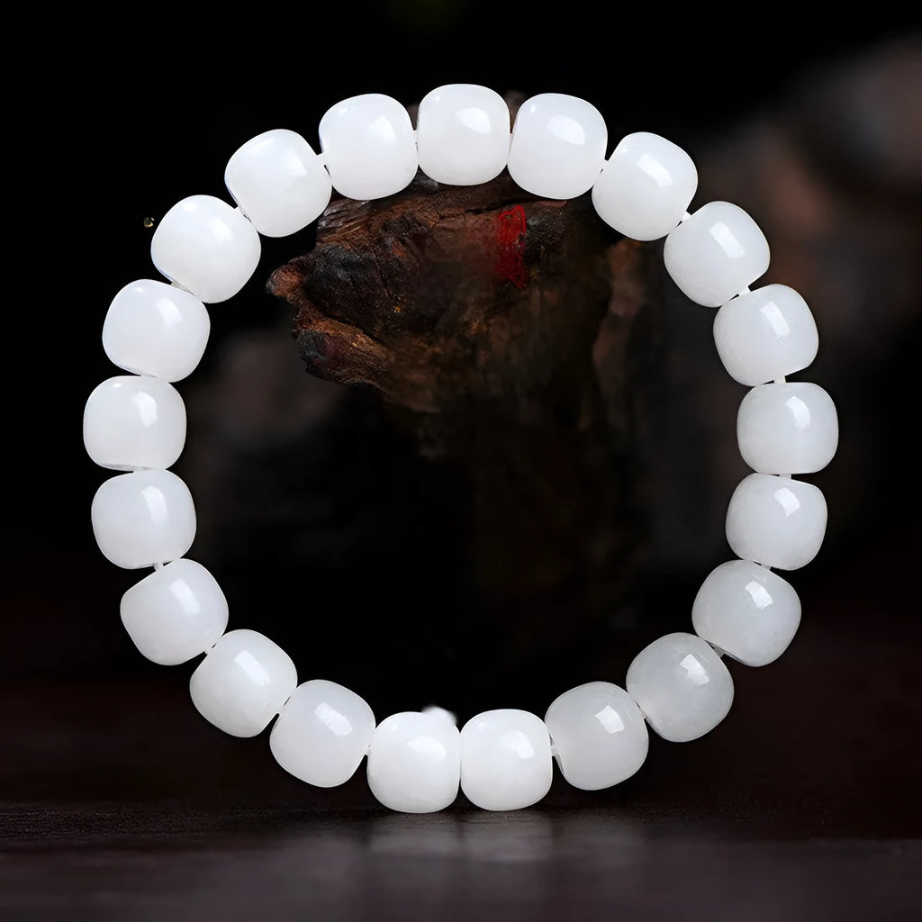 Handmade white Hetian jade barrel bead bracelet for men and women on a wrist.