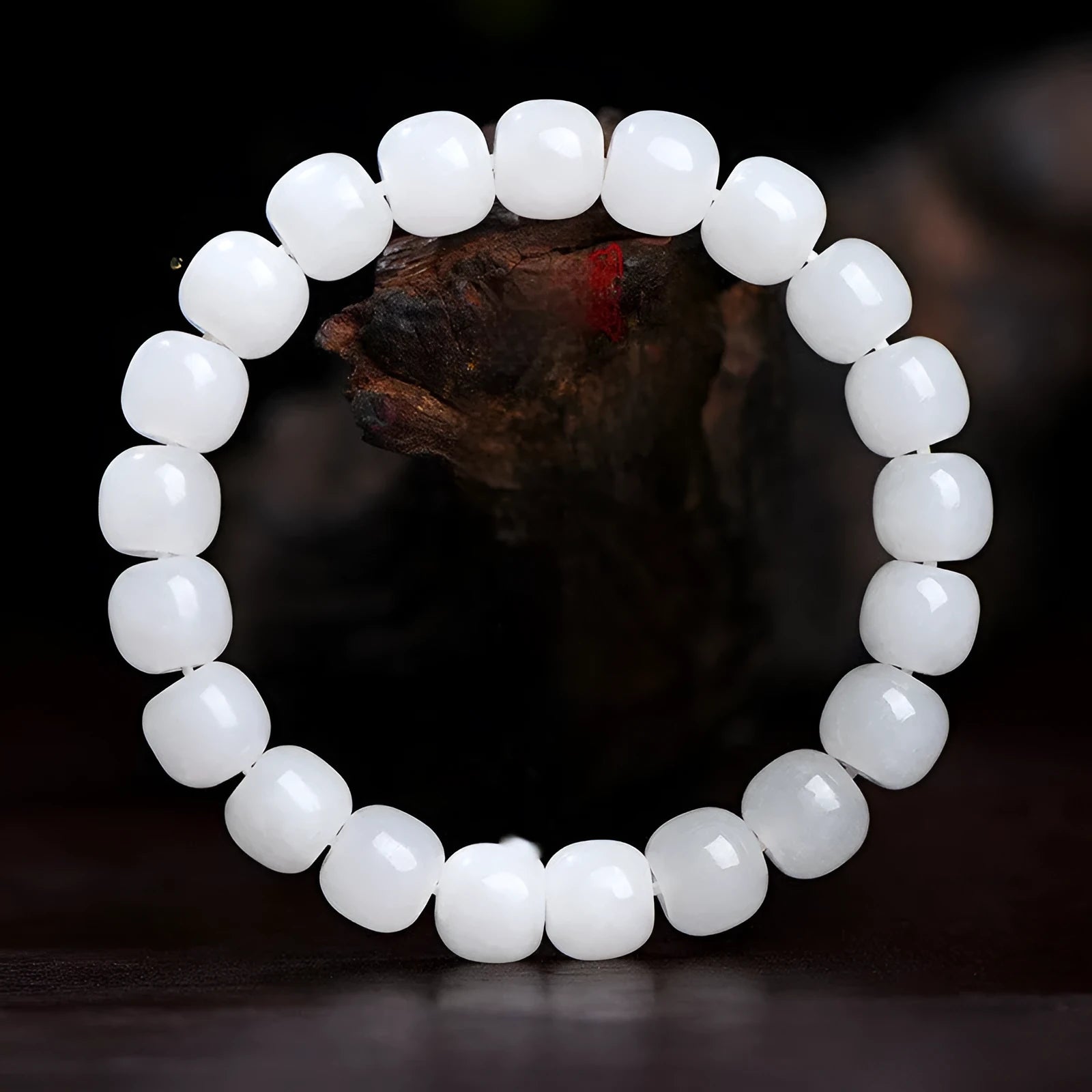 Handmade white Hetian jade barrel bead bracelet for men and women on a wrist.