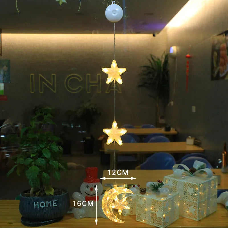 Three Christmas LED light ornaments with suction cups hanging on window