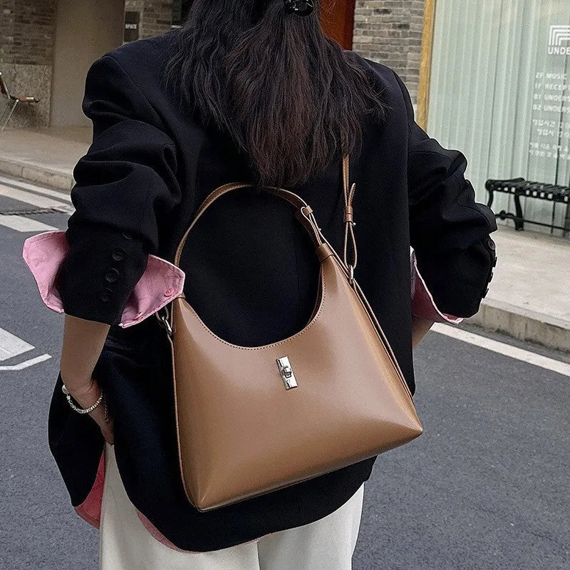Genuine cowhide leather crossbody shoulder bag in dumpling shape with organised internal compartments