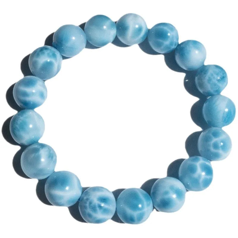 Blue Maillard style bodhi bracelet with natural crystal, sea-pattern stone, and pearls on a white background.