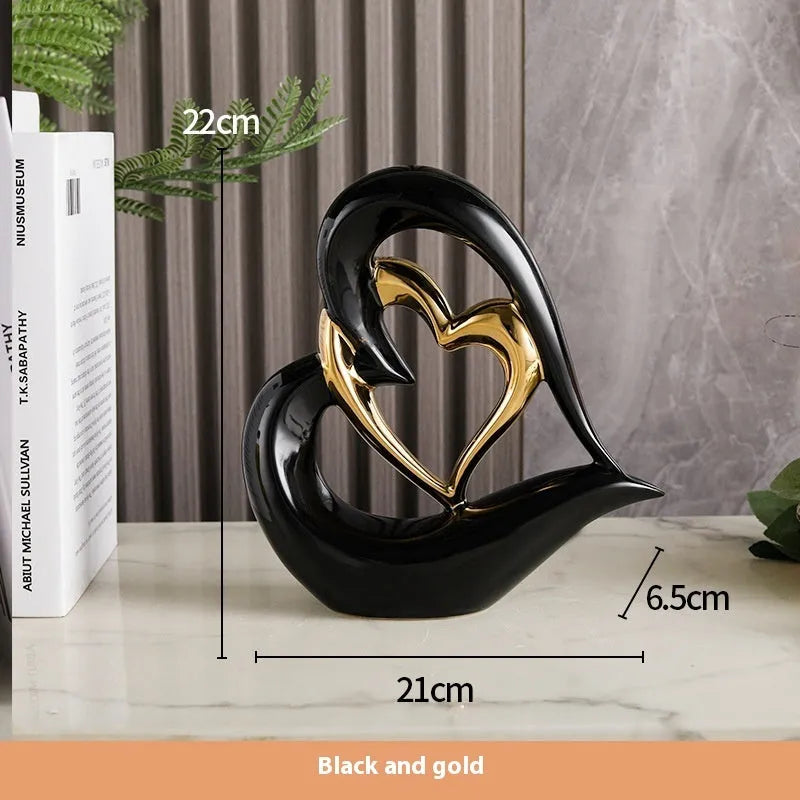 Modern white porcelain heart ornament with a geometric shape on a wooden surface.