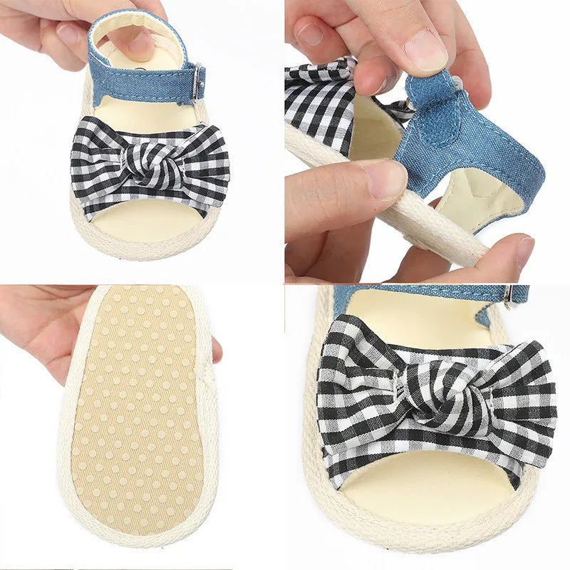 White and black toddler shoes with Velcro strap, showing low tube height design.