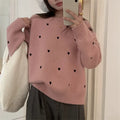 Women's loose grey acrylic pullover sweater with embroidery on the front.