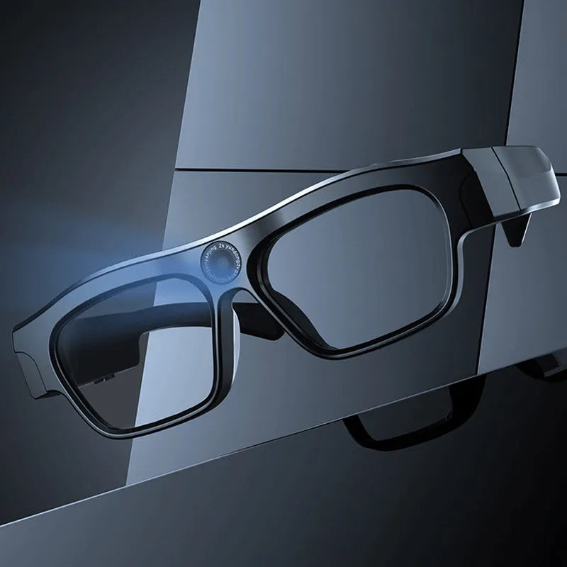 Black head-mounted smart glasses with camera and transparent lenses on a stand.
