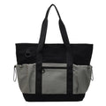 Lightweight Oxford cloth travel bag for women in grey, shown with a letter-pattern lining and holding a yoga mat.