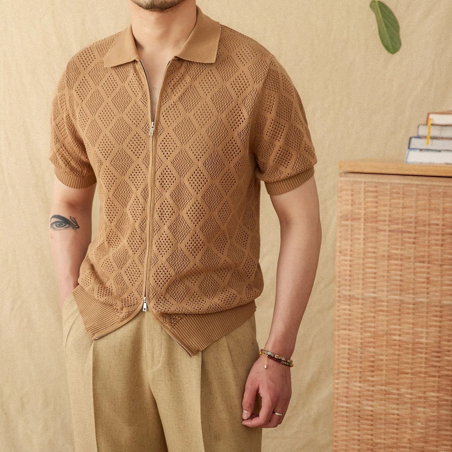 Men's light brown cotton cardigan with lapel collar, zipper front, and short sleeves laid flat.
