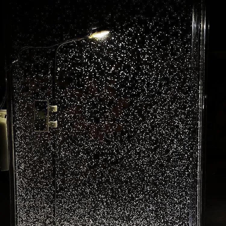 DIY snowy landscape Christmas night light with flowing snow effects and small street lamps on desktop