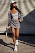 Women's blue street style hooded jacket and mini skirt outfit set on a hanger.