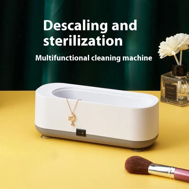 Small purple light ultrasonic glasses washing machine with USB cable and mirror cloth on white background