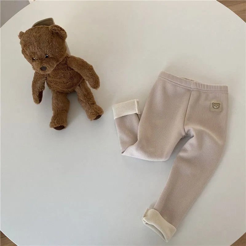 Girl's high-waist fleece-lined winter leggings in solid colour with wool lining and hair band belt.