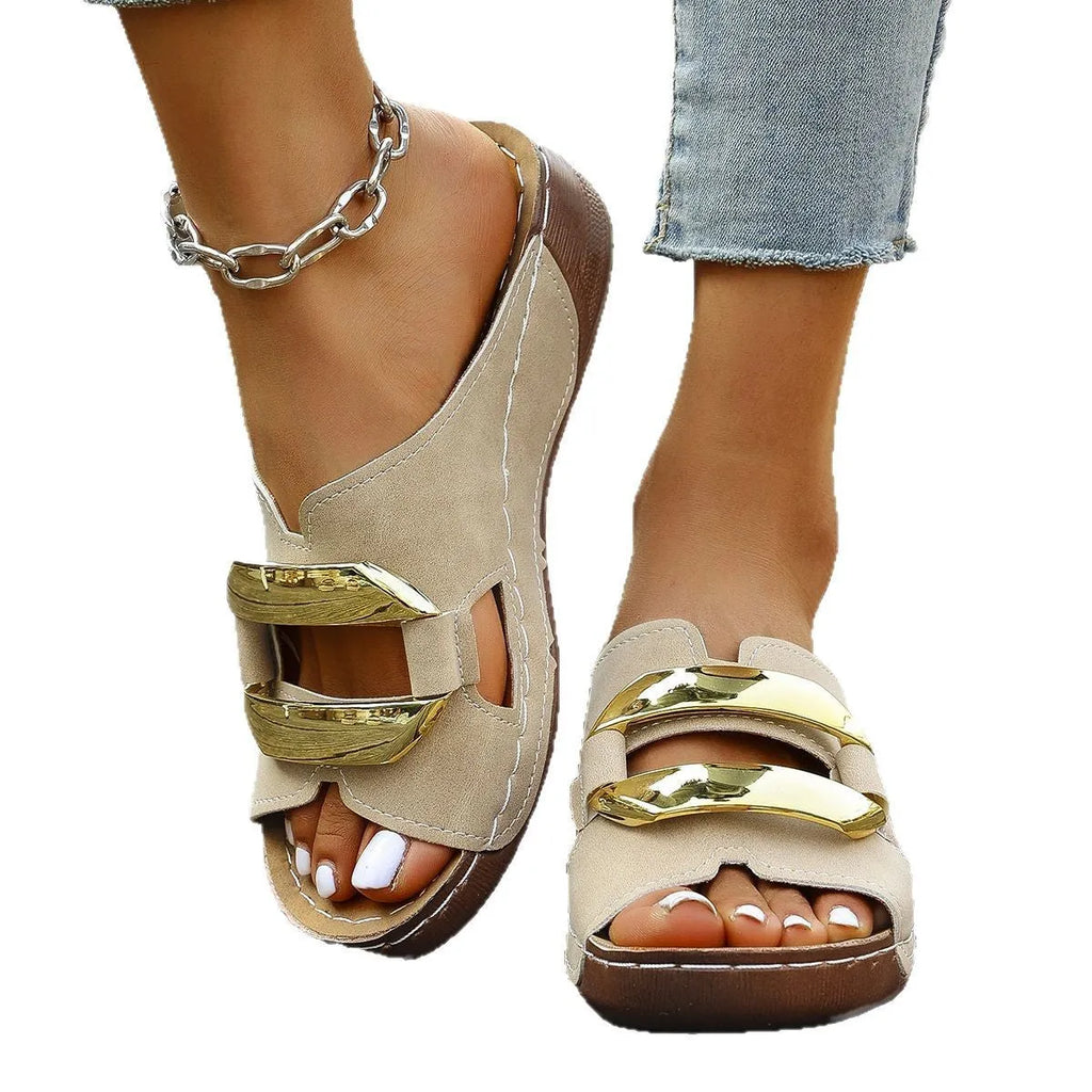 Roman style platform sandals in black, featuring a flat heel, rubber sole, and metallic decorative details.