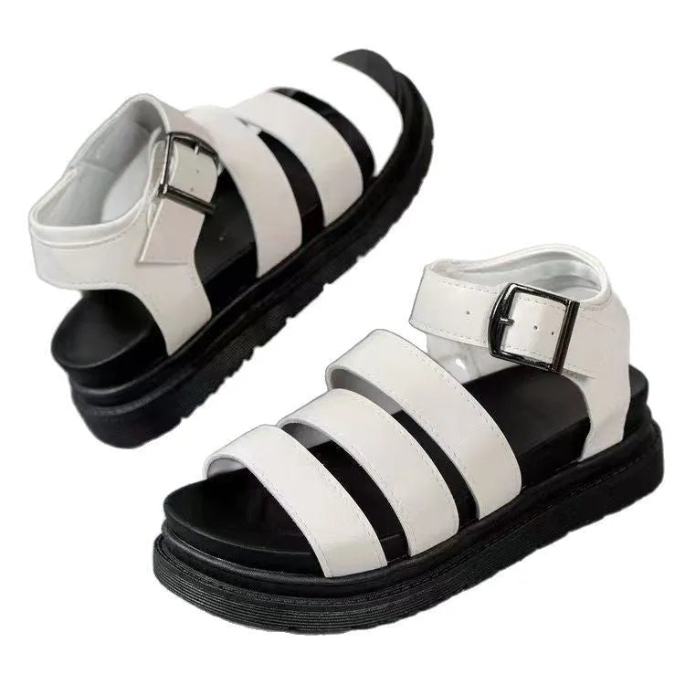 Black beach sandals with thick rubber soles and silver buckle strap fastening
