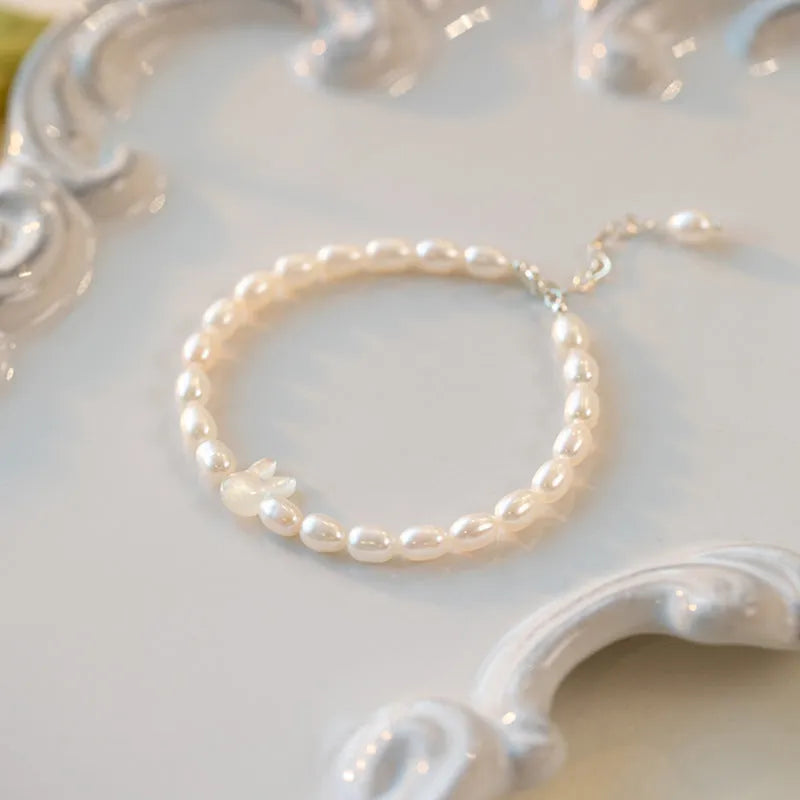 Handmade white shell pearl bracelet with 925 silver rabbit charm on 16cm elastic cord