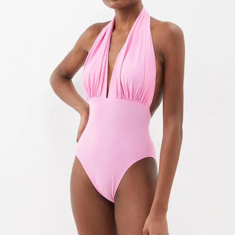 Women's deep V halter neck backless one-piece swimsuit with a floral print and removable skirt.