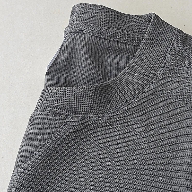 Men's dark grey heavyweight waffle-textured short-sleeved t-shirt on a hanger.