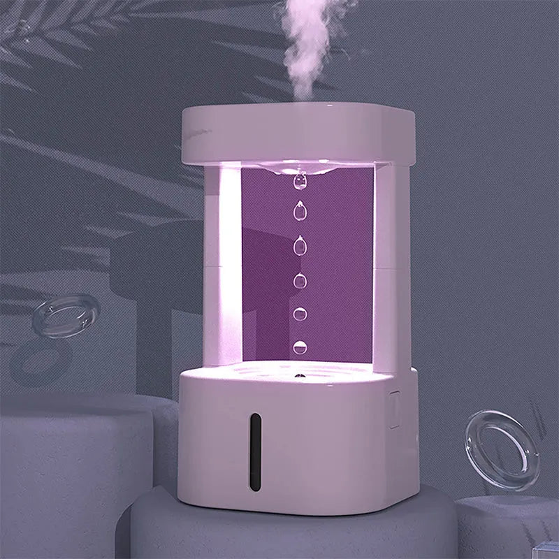 White anti-gravity water droplet USB humidifier with coloured lights on a desk