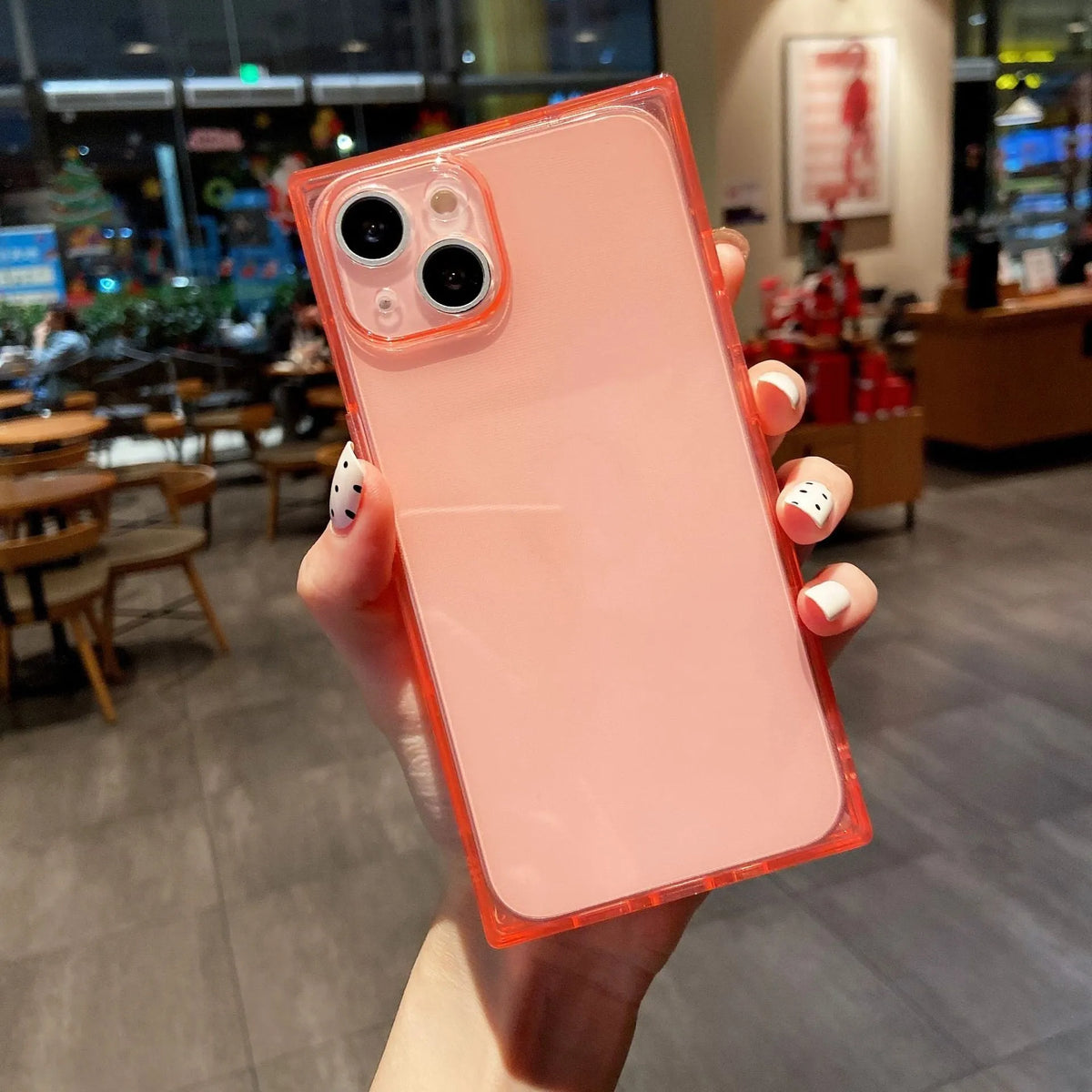 Square fluorescent TPU phone case for iPhone 13 in violet showing embossed texture and camera cutout