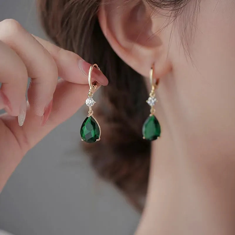 A pair of green geometric teardrop clip-on earrings made from alloy.