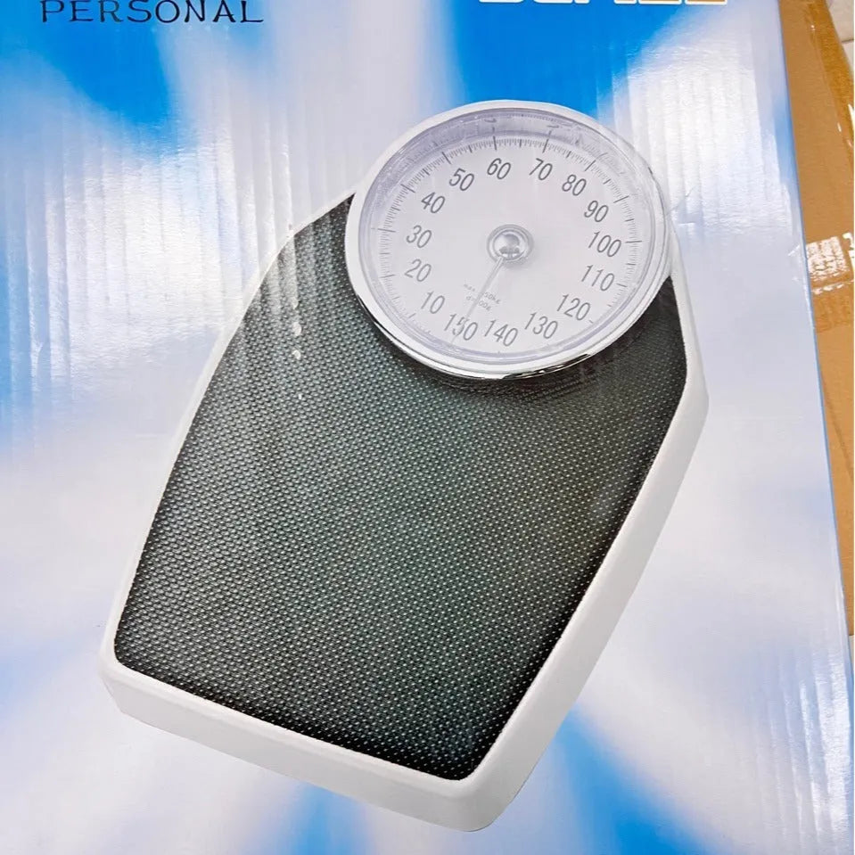 Black mechanical body weight scale with large analogue dial showing pointer display.