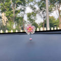 Blue plastic cute swing car decoration ornament, approximately 5cm tall.
