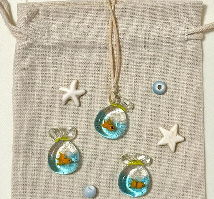Women's necklace with coloured glaze joker charm on a cotton and linen clavicle chain