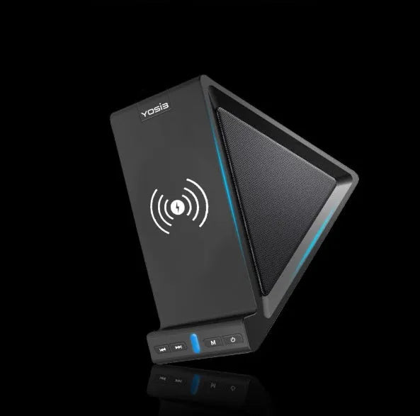 Black Bluetooth speaker with built-in stand holding a mobile phone on a desk.