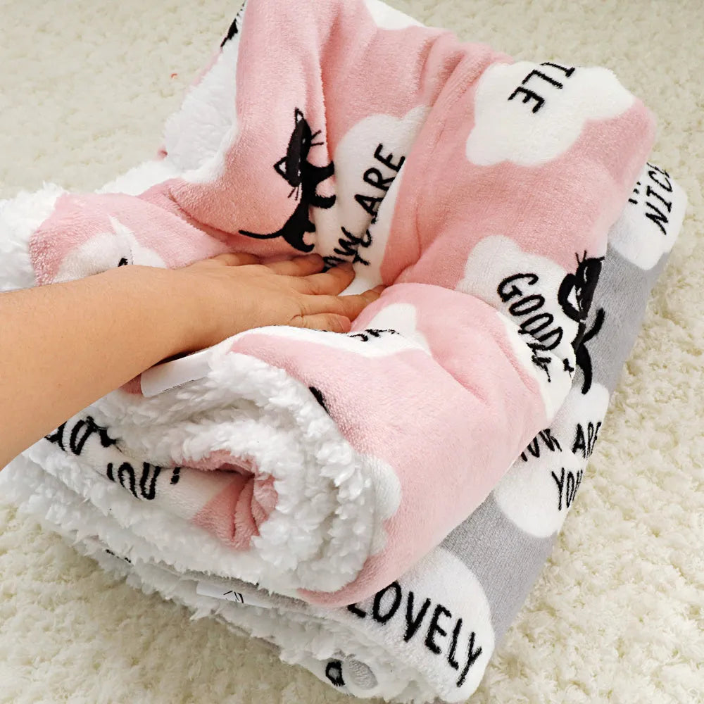 Lambskin pet blanket in flannel cashmere with cute cartoon pattern, grey colour, 55x70cm size on a pet bed