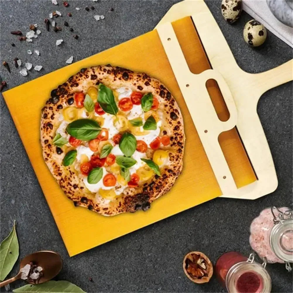 Food-grade PP plastic pizza transfer shovel on a kitchen counter, showing its size and hanging hole.