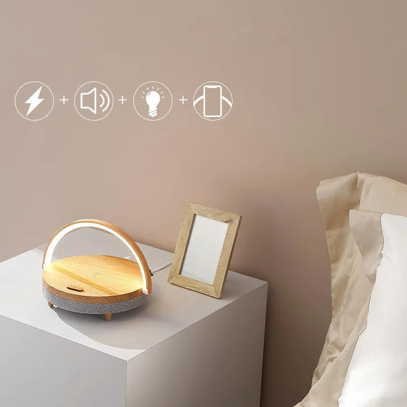 Wireless charging LED night lamp with Bluetooth speaker in marble pattern finish showing phone on charging surface
